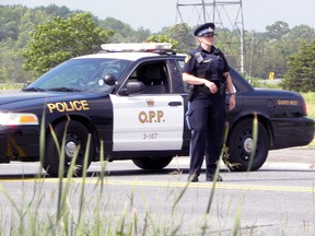 A Quinte West OPP officer blocks part of the road near Highway 401 overpass at Glen Miller Road Tuesday afternoon. Unconfirmed reports say a person jumped from the Glen Miller Road overpass onto Highway 401. 
Ernst Kuglin Photo QMI Trentonian