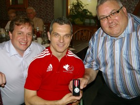 Silver-medalling Paralympian Dave Willsie receives a Queen Elizabeth Diamond Jubilee Medal on Tuesday from Elgin-Middlesex-London Tory MP Joe Preston, right, and EML PC MPP Jeff Yurek.