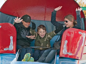 Deanna D'Ignazio (left), her six year old son Quinn, and Chistina Janiec are all smiles as they ride the Tilt-A-Whirl midway ride at last year's Burford Fair. (BRIAN THOMPSON Brantford Expositor)