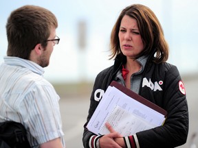 PHOTO COURTESY OF DYNAMIC PHOTOGRAPHY. Times' editor Kevin Rushworth interviews Danielle Smith ahead of the media scrum about her concerns about being kicked out of the EOC, residents not being allowed back into their homes and pet rescue efforts.