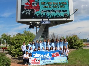 The Edmonton Strikers pose for a picture under the Powerplay Cup promotion sign at Commonwealth Stadium on Sunday, June 23, 2013. Four electronic signs featuring the Powerplay Cup promo were donated to the first-year soccer tournament. PHOTO SUPPLIED Leslie Gouveia