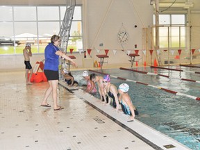 Alice Boll, head coach of the Blue Dolphins swim club, explains some of the mechanics of the butterfly stroke during team’s first official practice after hosting the Wacky and Weird swim meet on June 16.
Barry Kerton | Whitecourt Star
