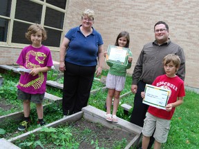 The Toyota Evergreen fund gave Central Public School a $340 donation for school's garden program. Left to right, Julian Brooks-Connon, Grade 1 student, Janet Thomson, vice principal, Lydia Buckler, Grade 2 student, Mike Berry, manager Woodstock Toyota, and Josh Brooks-Cannon. 
(TARA BOWIE / SENTINEL-REVIEW / QMI AGENCY)