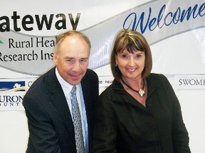 Gateway Rural Health Research Institute president Gwen Devereaux cuts a celebratory cake with Dr. Dave Edwards, of the University of Waterloo’s School of Pharmacy as the two organizations renew their Memorandum of Understanding.