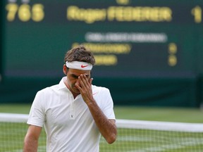 Roger Federer reacts during his  men's singles tennis match against Sergiy Stakhovsky at the Wimbledon Tennis Championships in London, England, June 26, 2013. (STEFAN WERMUTH/Reuters)