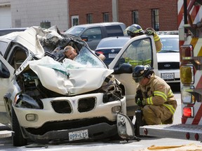 Two elderly people are fortunate to be alive after their mini-van collided with a 45,000 kilogram crane  in London, Ontario on Wednesday, June 26, 2013. (DEREK RUTTAN/The London Free Press/QMI AGENCY)