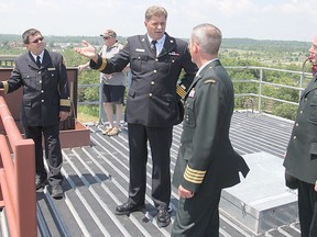Kingston Fire & Rescue Deputy Chief Don Corbett, second from left, takes visitors to the top of the fire department's new training facility, which officially opened on Wednesday.
Michael Lea The Whig-Standard