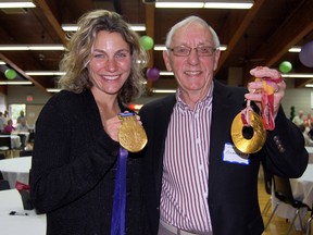 Two-time Olympic gold medalist with the Canadian Women's Ice Hockey Team, Cheryl Pounder, left, and former Multi-Service Centre chair John Armstrong show off Pounder's gold medals during the Tillsonburg and District MSC 35th Anniversary celebrations Tuesday evening at the Tillsonburg Community Centre. Pounder was guest speaker for the event and shared a motivational message. KRISTINE JEAN/TILLSONBURG NEWS/QMI AGENCY