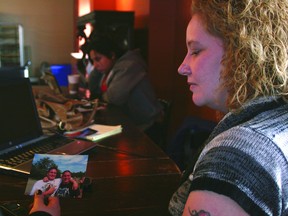 Lori Astley, mother of James and William Beck — the identical twins murdered last June — looks at photos of her slain sons last year before the eight-month anniversary of their unsolved death. TODAY FILE PHOTO