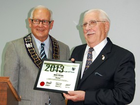 Tillsonburg Mayor John Lessif, left, presents Tillsonburg's 2013 Ontario Senior of the Year to Robert Marsden Monday evening at town council. Marsden was recognized for his years of service and contribution to the community. KRISTINE JEAN/TILLSONBURG NEWS/QMI AGENCY