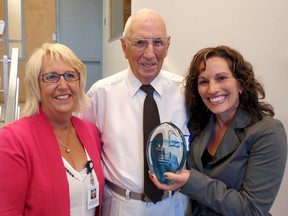 Michele Grzebien-Huckson, left, executive director of the Foundation of Chatham-Kent Health Alliance congratulates long-time donor Ed Coyne and Jennifer Demars of Pro Resp Inc. of Chatham, whose firm was recognized as an outstanding sponsor of the foundation, during the foundation's annual general meeting, Wednesday, June 26, 2013, in Chatham, Ont. (BOB BOUGHNER, The Daily News)