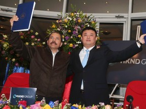 Nicaragua's President Daniel Ortega, left, and Wang Jing, chairman of the Hong Kong international company Nicaragua Canal Development Investment Co. (HKND Group) celebrate signing a concession agreement for the construction of an inter-oceanic canal in Nicaragua at the Casa de los Pueblos in Managua June 14, 2013. (REUTERS/Jairo Cajina/Presidential Palace Nicaragua/Handout via Reuters)