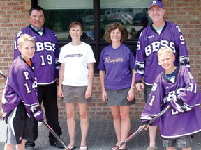 Back row from left, Bob Kowal, vice-principal of Beaver Brae, Gayle Mutrie, vice-principal of King George, Lynn McAughey, principal of King George, and Dave Tresoor, head coach at the hockey academy at Beaver Brae, smile while Carter Tresoor, left, and Zachary Beaulne, right, get ready for a puck drop. King George announced it will be working with the hockey academy at Beaver Brae by offering hockey sessions once a week to Grade 5 and 6 students.