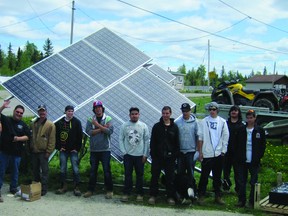 Court Seymour Etherington, Peter Iserhoff, Max Robert Cohnstaedt, Joel Robin, Christopher White, Morgan Hunter, Bernard Whiskeychan-Hunter, Kynewh Enosse, Simeon Edwards, Brett Filion and Ryan Prevost in front of the solar panels they constructed through the Apitisawin Construction and Solar Fundamentals program.