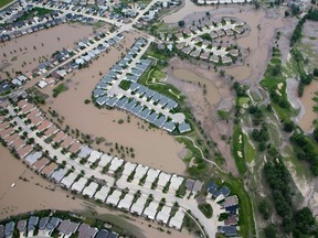 Houses and a golf course are surrounded by flood water in High River, Alberta, south of Calgary June 23, 2013. REUTERS/Andy Clark