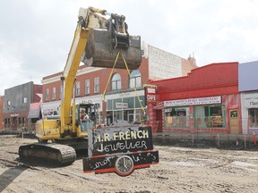 Construction crews help to move the historic French’s Jeweller (now known as French’s Jewellery) sign across the street to it’s new location.