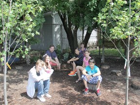 Grade 6 Victor Lauriston Public School students have been enjoying a unique learning environment in the outdoor shaded classroom in a quiet corner of the school property. Pictured, here from left to right are: Dale Archibald, 11, Stephanie Dorion, 11, Ben McCabe, 20, a student tutor, Pam Lucio, a Grade 6 teacher, Julian Ferrell, 12, Megan VanDusen, 11 and Luca Iaconetti, 12. Photo taken Thursday, June 28, 2013, in Chatham, Ont. (ELLWOOD SHREVE/ THE CHATHAM DAILY NEWS/ QMI AGENCY)