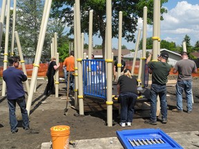 Parent volunteers got a jump start on their weekend and began building the playground at 8:30 a.m. on Friday, June 21. - Caitlin Kehoe, Reporter/Examiner