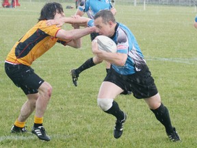 Parkland’s Scotty McLaren prepares to straightarm an Edson tackler out of the way during their game which ended in a 44-12 Sharks win. - Gord Montgomery, Reporter/Examiner