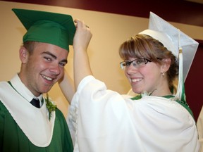 Jessica Edel adjusts Phillip Maneau's mortar-board moments before the O'Gorman High School Graduation ceremony at St. Anthony of Padua Cathedral in Timmins. They were among the 84 graduates who received their high school diploma Thursday.