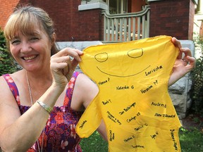 Erika de Wet, a volunteer at Hospice Kingston, holds up the fabric character containing names of some of the people who donated money for her recent 900-kilometre walk across Spain.
Michael Lea The Whig-Standard