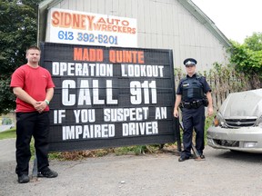 Allen Magee of MADD Quinte and Const. Dave Lundington of the Quinte West OPP are reminding drivers to call 911 if they see a suspected impaired driver this long weekend. They are shown here at a sign reminding drivers of Operation Lookout 911 at Sidney Auto Wreckers in Trenton, ON, Thursday, June 27, 2013.

Emily Mountney QMI Agency