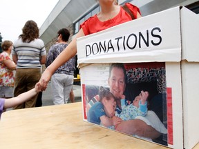 Hundreds of people support B.J. (Will) Ketcheson and his family during a fundraising barbecue at Belleville Police Service Thursday as the 33-year-old Napanee native battles cancer .
JEROME LESSARD The Intelligencer