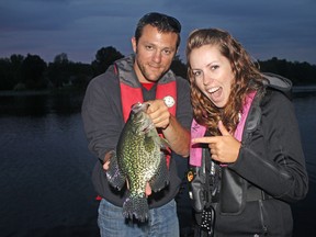 Jerome Richard, left, of France, holds a 13.5-inch black crappie caught and released in the Bay of Quinte while visiting columnist Ashley Rae, right.
(Caroline Richard)