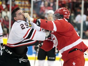 Owen Sound Attack Kurtis Gabriel (29) gets a punch in the face by Soo Greyhound David Broll (17) in the first period, of Wednesday, March, 27, 2013, playoff game, at Essar Centre in Sault Ste. Marie, Ont. Game 4 of their best of 7 series.