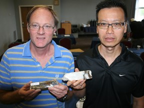 Senior consultant Pat Pope, left, and Gary Wong, vice-president of exploration with Rapier Gold, show core samples that have been taken from a property about 75 southwest of Timmins. Pope is holding core sample from a drill program conducted in early 2000s that identified the first evidence of gold on that property. Wong is holding a core sample from the latest drill program that was conducted on the property this spring.