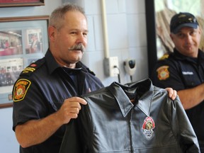 Capt. Graham Emslie retired after 35 years with the Sarnia Fire and Rescue Service Thursday. The 59-year-old was sent off in style with a retirement party at the East Street fire station. A jacket with the Sarnia Professional Firefighters Community Benefit Fund logo was one of several gifts he received. TYLER KULA/ THE OBSERVER/ QMI AGENCY