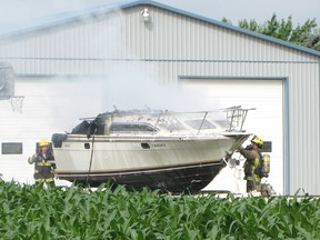 Firefighters were called to a Prince Albert Road home on the outskirts of Chatham on Friday morning to battle a boat fire. Vicki Gough Photo/Sunmedia