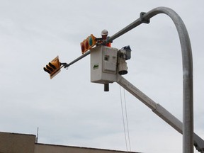 Crews were busy installing the new traffic lights at Main Street and MacLeod Ave on Tuesday, June 25.