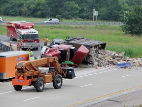 An overturned garbage truck caused the closure of Highway 402 westbound lanes at Oil Heritage Road, Friday morning. TARA JEFFREY/THE OBSERVER/QMI AGENCY