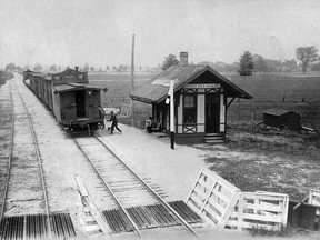 Two people are dashing to get on the caboose of the freight train departing from the Mount Pleasant Station. The overhanging roof protected the passengers from the elements while an outhouse was also on site for convenience. (Photo c. 1895, Ontario Archives, Linda Guest Collection)