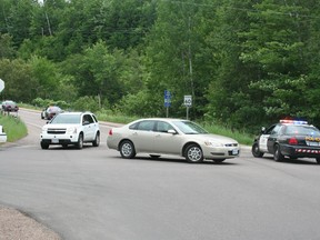 SEAN CHASE   OPP cruisers race up Laurentian Drive during a manhunt for a suspect involved in a suspicious death at Petawawa Point Friday.