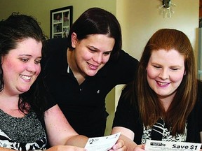 Couponers (l-r) Jennifer Dennis, Ashley Thompson, Ashley Bray and Katie Belisle sort through thousands of coupons distributed through members of the Kingston Coupon Exchange.       ROB MOOY - KINGSTON THIS WEEK