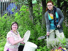 Brooke Gilmour, program manager of Hearthmakers and Jolene Simko, program coordinator of RAIN demonstrate the simplicity of helping our water system by composting pet waste. A free series of workshops will be offered this July.