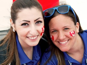 Timmins Police Youth Ambassadors Kaitlin Wheeler and Megan Roy spent Friday handing out Canadian Flags and temporary tattoos. The Downtown Timmins Business Improvement Association hosted Canada Day activities in its Urban Park on Friday.