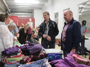 Nanton News - June 20 - Doug Griffiths and Fred Horne tour the Nanton evacuation centre at the Tom Hornecker Recreation Centre, reviewing donated goods organized by teams of volunteers.