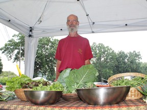 Richard Tunstall of Heart's Content Organic Farmstead mans a booth at Paris Farmers' Market on opening day, Thursday, June 27, 2013. The market runs until Thanksgiving. MICHAEL PEELING/The Paris Star/QMI Agency