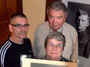 Owen Sound Museums board members (L-R) Dave Alexander, Gloria Habart and John Totton with the signed image of Billy Bishop. DENIS LANGLOIS