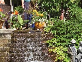 Fran Holloway is pictured with a waterfall in her garden, one of eight gardens that will be featured in the Stratford and District Horticultural Society’s garden tour Sunday, July 7. (LARKE TURNBULL, Contributed photo)