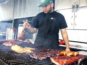 Marwan Nasta of Jack the Ribber cooks up a finger-licking good storm at the opening of the Timmins Rotary Ribfest on Friday. Route 55 Ribs and Railroad Ribs will be the others to challenge for best ribs in town. The contest is just one of the many activities at this year's event.