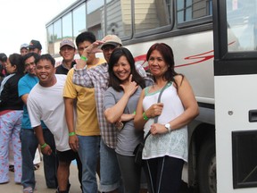 Laine Burgos and Brendalyn Bugsangit are the first two people on the bus to tour High River. With them are Joel Mercado adn Fidel Copioso