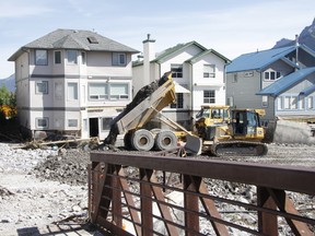 Work crews shore up the east bank of Cougar Creek in Canmore on Friday, June 28, 2013 in front of red-zoned residential homes. Russ Ullyot/ Bow Valley Crag & Canyon/ QMI Agency