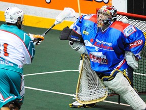 Peterborough Lakers' goalie Tyler Carlson stops a shot against Six Nations Chiefs' Roger Vyse during first period during Major Series Lacrosse action on Thursday, June 27, 2013 at the Memorial Centre in Peterborough. (Clifford Skarstedt/Peterborough Examiner/QMI AGENCY)