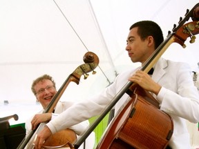 Patrick Staples, right, plays his bass during warm up while fellow bass player, Paul Nagelberg, left, looks on. The Winnipeg Symphony Orchestra performed under the Whitecap Pavilion in Kenora on Friday, June 28.

GRACE PROTOPAPAS/KENORA DAILY MINER AND NEWS