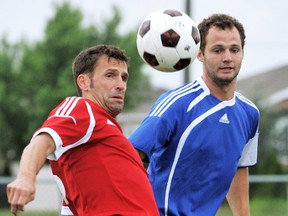 Chatham Express's Darby Kalp, left, and Wallaceburg Sting's Phil Nywening watch the ball in the first half of their Premier Division match in the Western Ontario Soccer League on Friday at Thames Campus Park. The Sting won 2-0. (MARK MALONE/The Daily News)