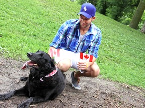 Bobby France and his dog Bella showed off their patriotic colours at John Waddell Dog Park on Saturday June 29, during a Canada Day celebration held by the Dog Off-Leash Recreation Area Committee. The committee hopes to accumulate $6,000 in donations to install new lighting around the dog park trail. KIRK DICKINSON/FOR CHATHAM DAILY NEWS/ QMI AGENCY